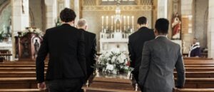 funeral church group carrying a coffin at a service