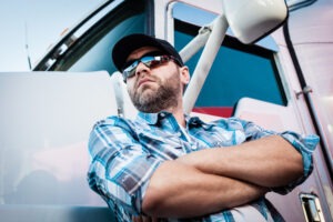 truck driver standing next to 18-wheeler