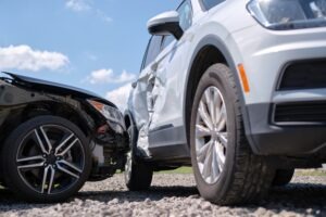 black car smashing into a silver car