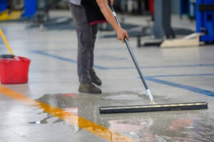 man cleaning garage floor
