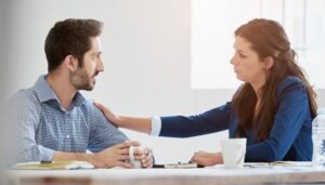 woman comforting male coworker