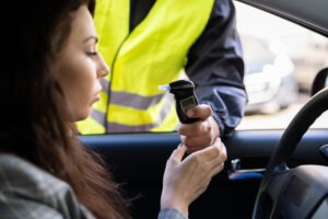 woman taking a breathalyzer test